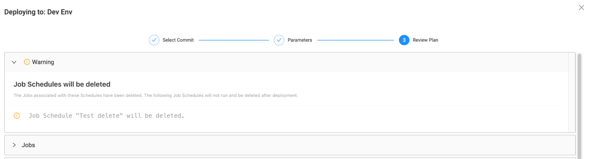 A deployment review screen with a warning message stating that certain job schedules will be deleted and will not run after deployment. A specific job schedule named Test delete is highlighted as being marked for deletion